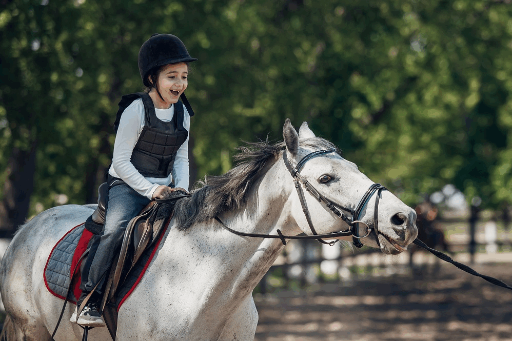 young girl riding a horse