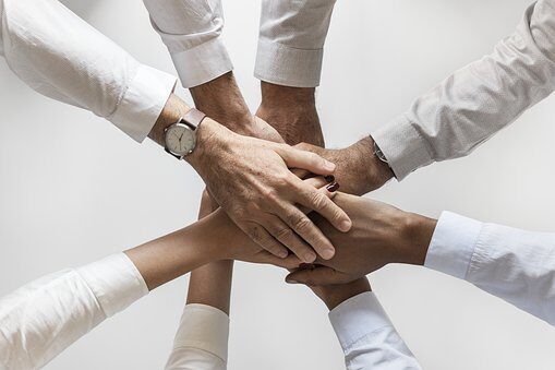 cropped-people-3152585__340.jpg several people's hands on top of each other